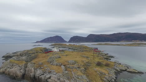 aerial view of a rocky island with red houses in norway