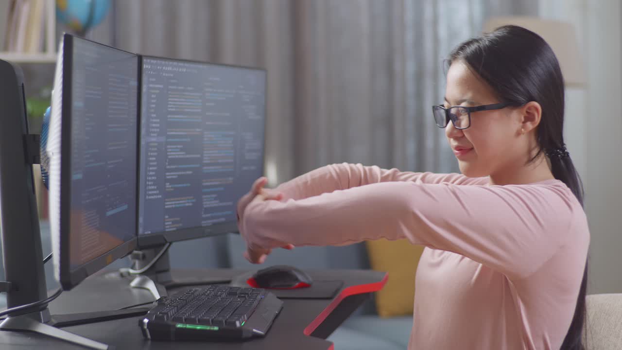 chica adolescente asiática programadora estirándose mientras crea ingeniero de software desarrollando aplicación, programa, videojuego en computadora de escritorio en casa. terminal con lenguaje de codificación