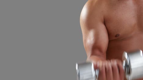 serious muscular man lifting dumbbells