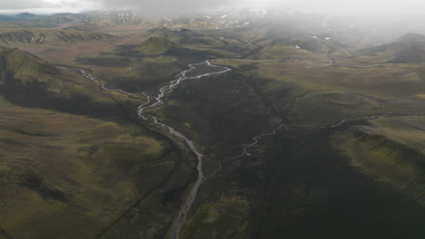 Wide-aerial-establishing-shot-of-lush-green-Iceland-valley-landscape