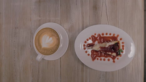 Woman-having-dessert-with-coffee-in-restaurant