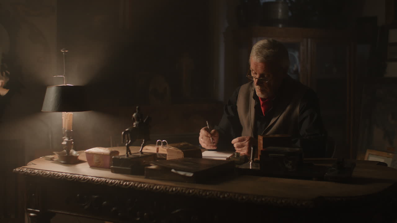 Older passionate man evaluates an old watch in his office at night