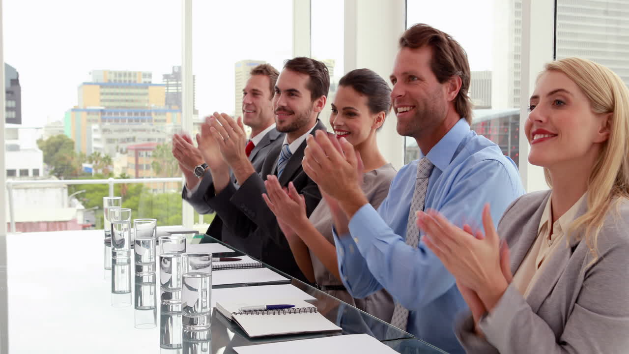 Interview panel applauding the applicant