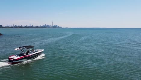 Aerial-shot-flying-past-a-boat-heading-towards-Toronto-on-Lake-Ontario