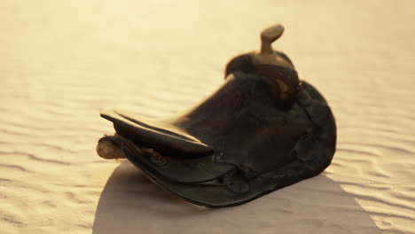 old horse saddle on the beach