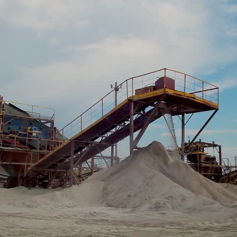 industrial factory for gravel production. metal construction for working with stone and rocks. elements of equipment for sorting rubble. production of construction materials.