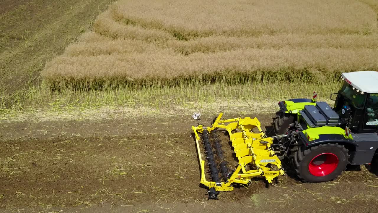 Tractor Working In The Agricultural Field. VINNITSA, UKRAINE - JULY 2017: Agricultural equipment ready for ploughing the fields