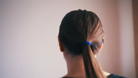 woman-with-long-ponytail-has-training-on-treadmill-in-room