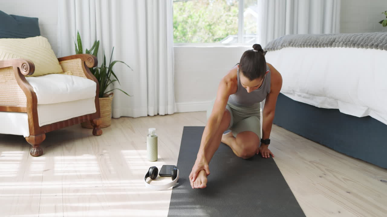 Woman practicing yoga on mat at home, focusing on relaxation and balance