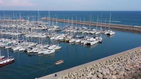 boat getting out of palavas-les-flots harbour aerial shot france