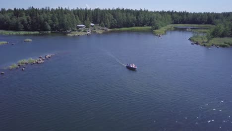 boating family cruising through summer archipelago in finland, aerial