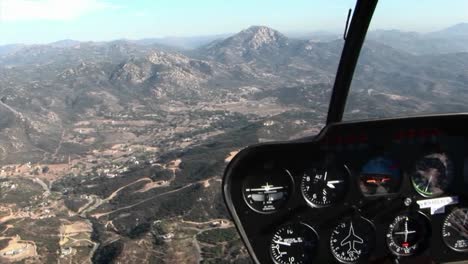 a plane flies over a mountainous area