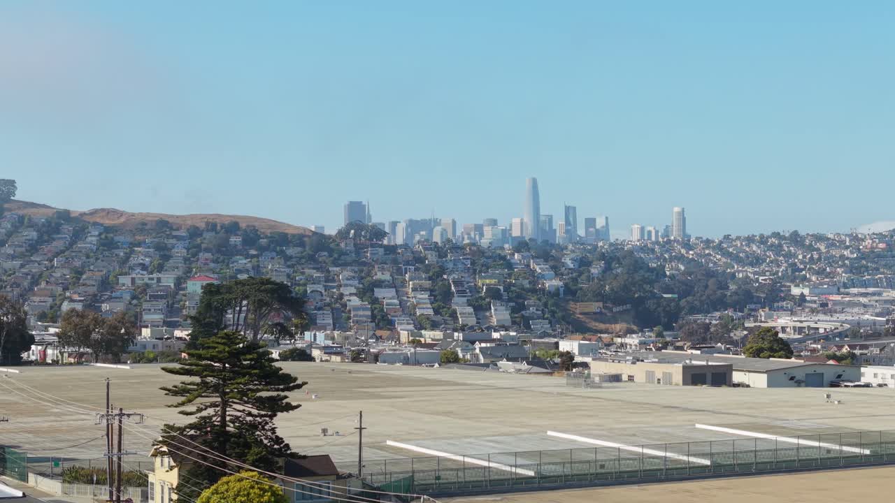Aerial view of Bernal Heights in San Francisco shows its circular summit and panoramic backdrop of city towers.