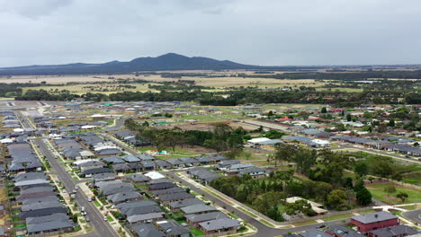 AERIAL-ARC-Over-Town-Of-Lara,-Australia-With-You-Yang-Mountain-Ranges