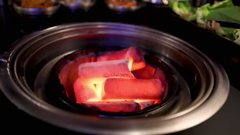 burning charcoal in a metal container