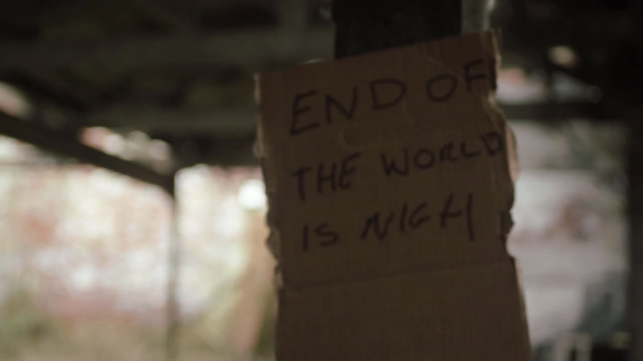 End of the world handwritten sign pinned to wall of old building