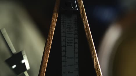 musical metronome side to side hypnotic pendulum tempo action close-up