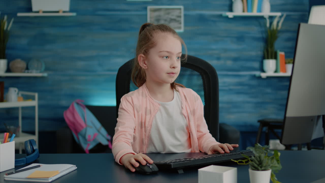 Elementary school child using computer and keyboard