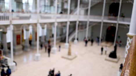 people exploring exhibits in spacious museum hall