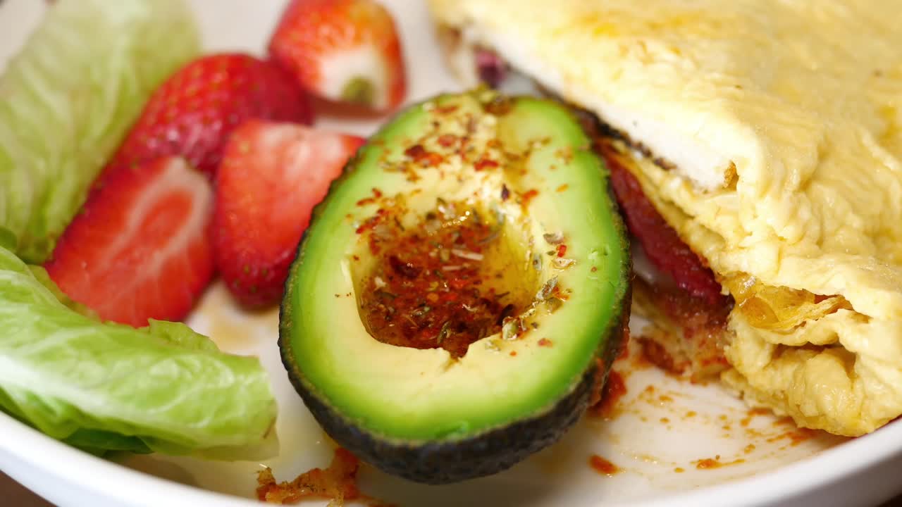 Healthy Breakfast with Avocado, Strawberries, and Omelet