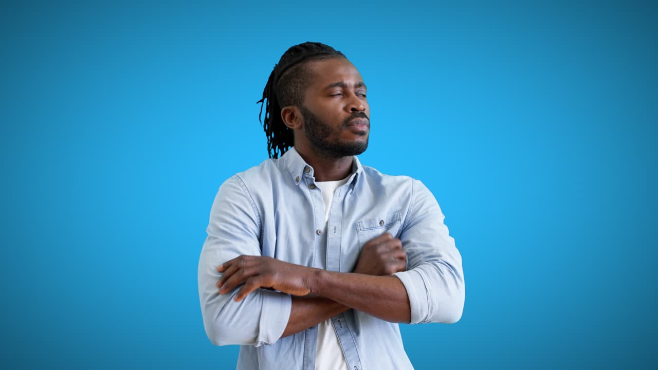Pensive young man on blue background thinking about new ideas, problem solution