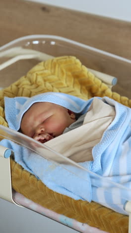sleeping newborn baby in hospital crib