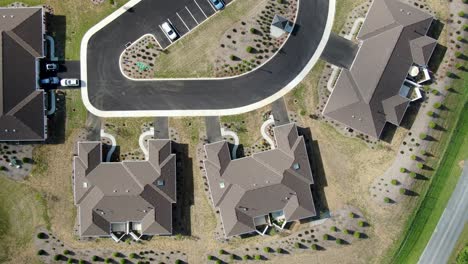 top down aerial of houses, new scrub landscaping, dry arid climate, brown monochromatic view with hints of green grass