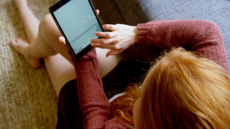 Woman-using-digital-tablet-in-living-room-4k