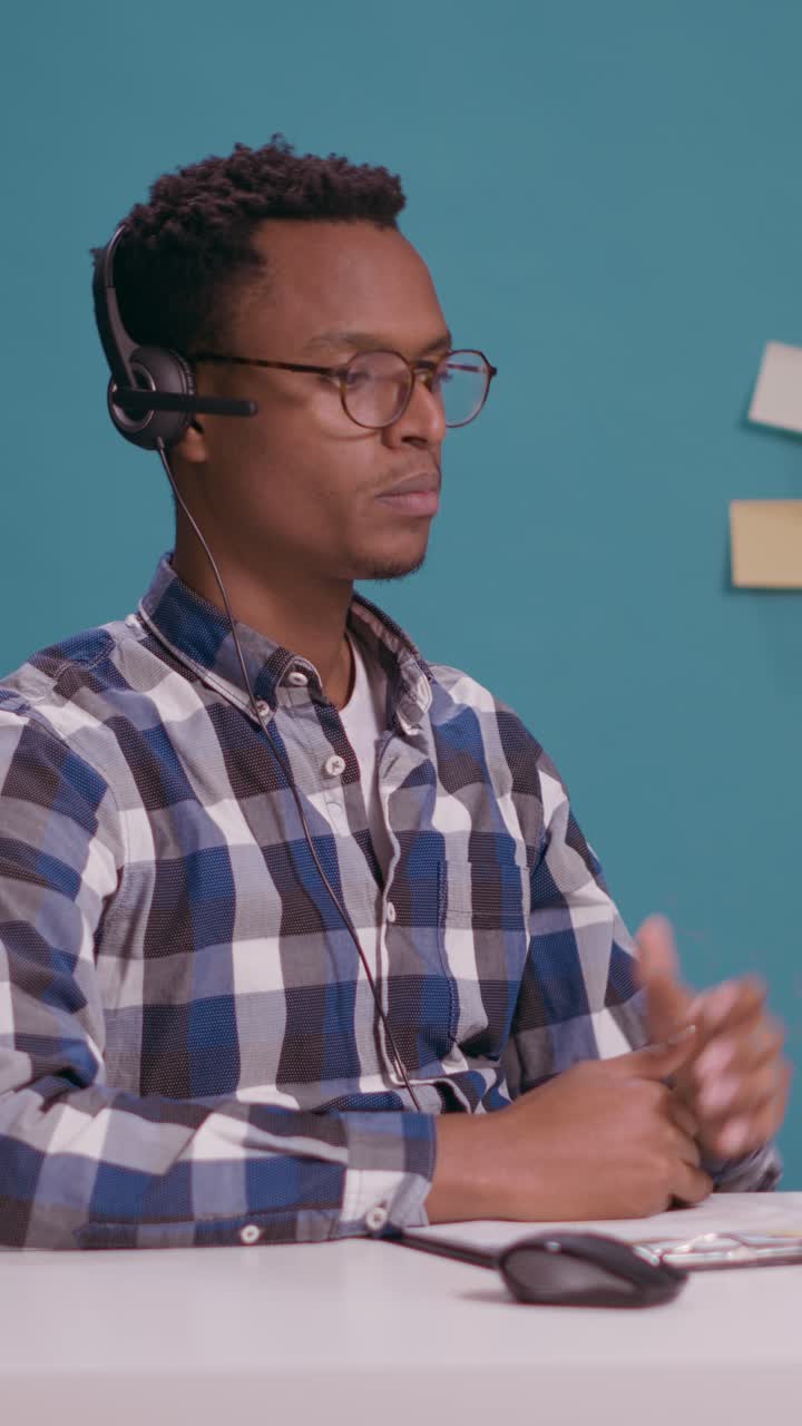 Man wearing headset working at desk