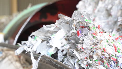 cinematic shot of shredded milk cartons in recycling plant