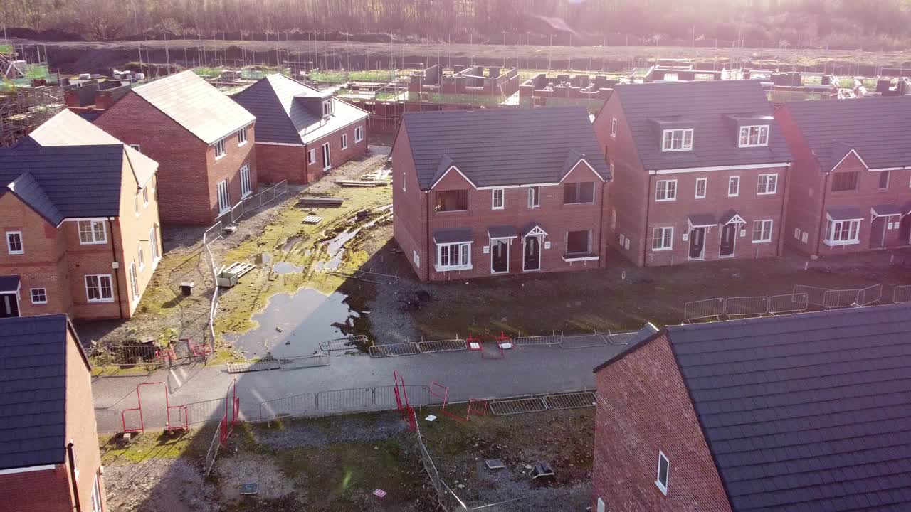 Unfinished waterfront townhouse property development construction site aerial view zooming in