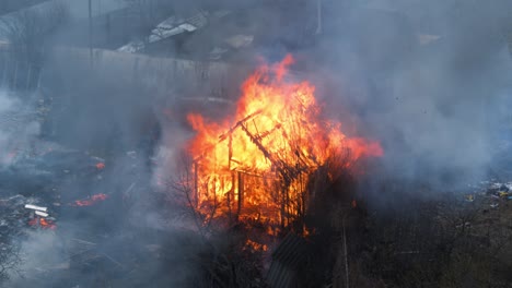 house in fire loop. seamless loopable footage of the burning wooden house