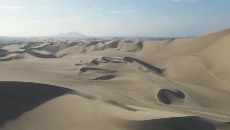 continuing the aerial spectacle, the drone drifts forward through ica's enchanting dunes