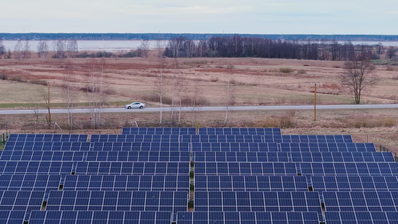 Overcast autumn morning in Latvia as car drives by renewable energy installation