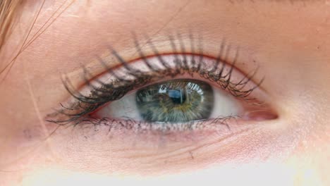 Close-up-of-woman's-eye-looking-at-business-skyscrapers