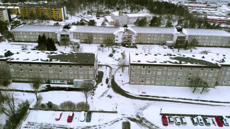 Aerial-over-buildings-and-cars-covered-with-snow-during-extreme-winters