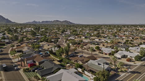 Scottsdale-Arizona-Aerial-v11-flyover-Chateau-De-Vie-neighborhood-along-the-driveway-capturing-residential-community-area,-cityscape-and-Camelback-mountain---Shot-with-Mavic-3-Cine---February-2022