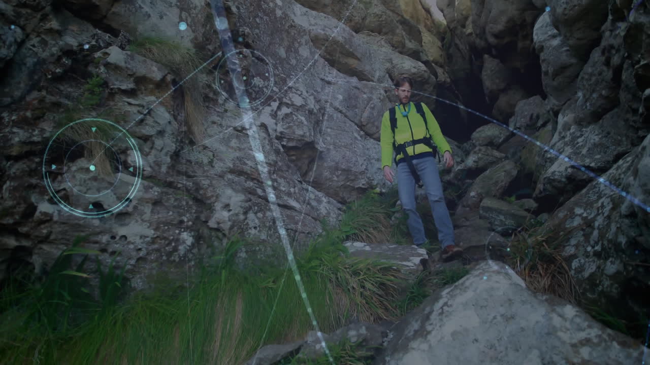 Male hiker descending rocky mountain pass, under digital navigation overlay for outdoor technology