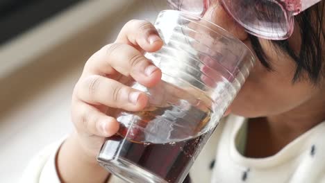 young girl drinking soda