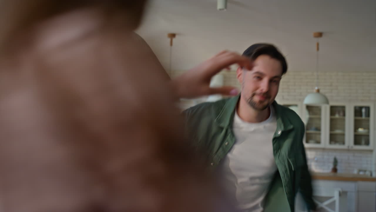 Closeup active spouses playing pillows living room together. Family having fun