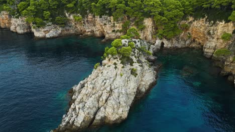 Kalamota-Island,-Adriatic-Sea,-Croatia---A-Stunning-Vista-of-the-Pristine-Azure-Waters-Hugging-the-Rugged-Coastline---Orbit-Drone-Shot