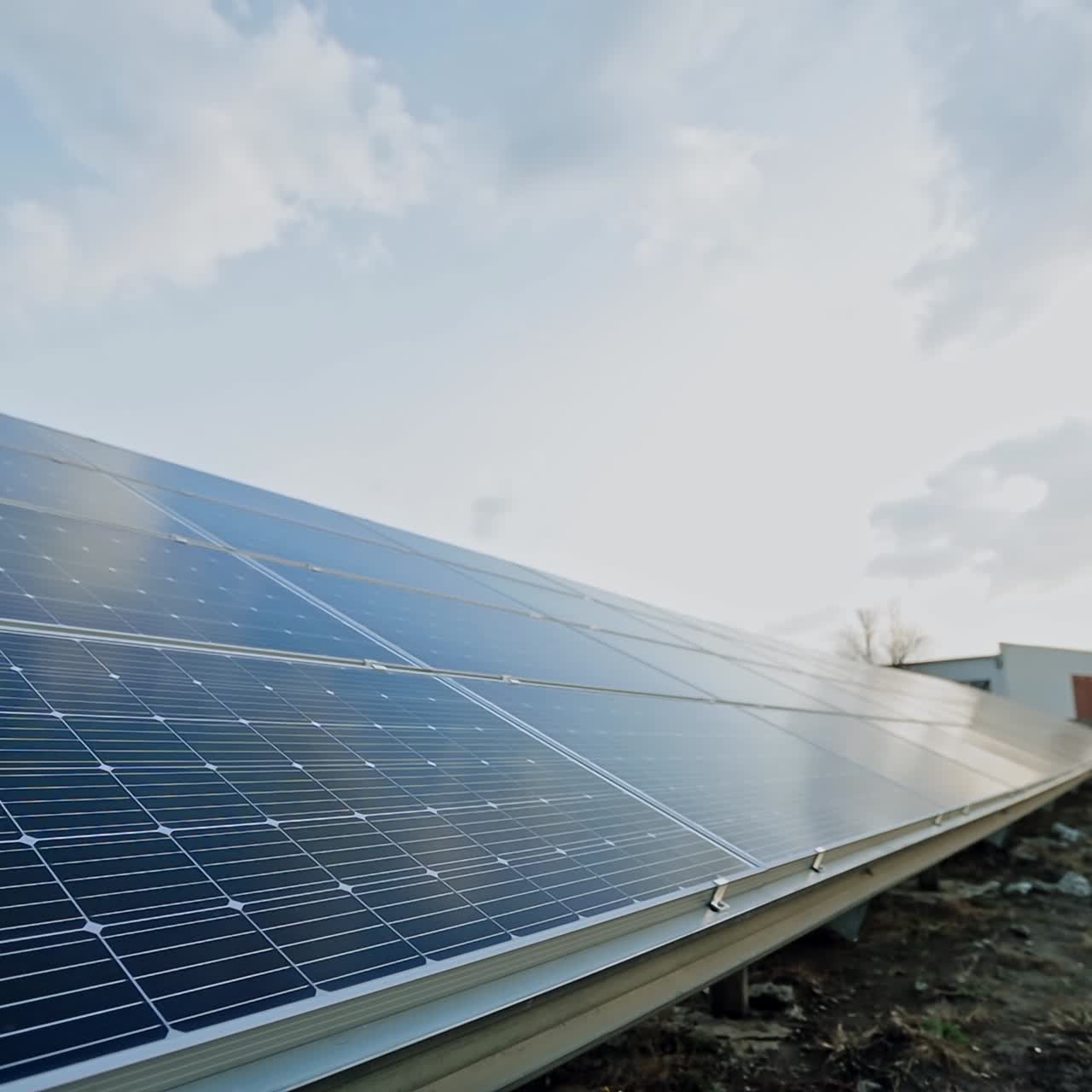 Big solar panels on the ground. Blue cells of the batteries in a sunny day get clean energy. Eco friendly energy production.