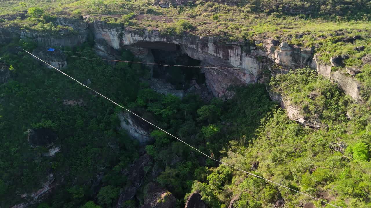Aerial descend zoom-in highliner on highline Gruta do Lapão, Chapada Diamantina, Bahia