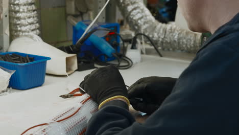 worker performing electronics repair