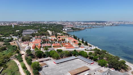 Drone-shot-from-Corrois-flying-towards-Almada,-with-Lisbon-at-the-horizon