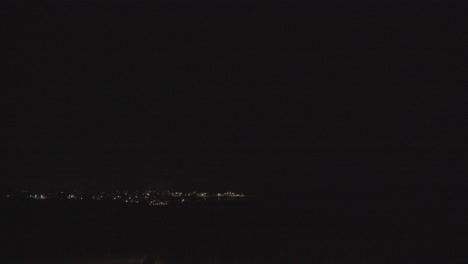 Summer-night-thunderstorm-and-dark-sky-with-clouds-over-an-island-village