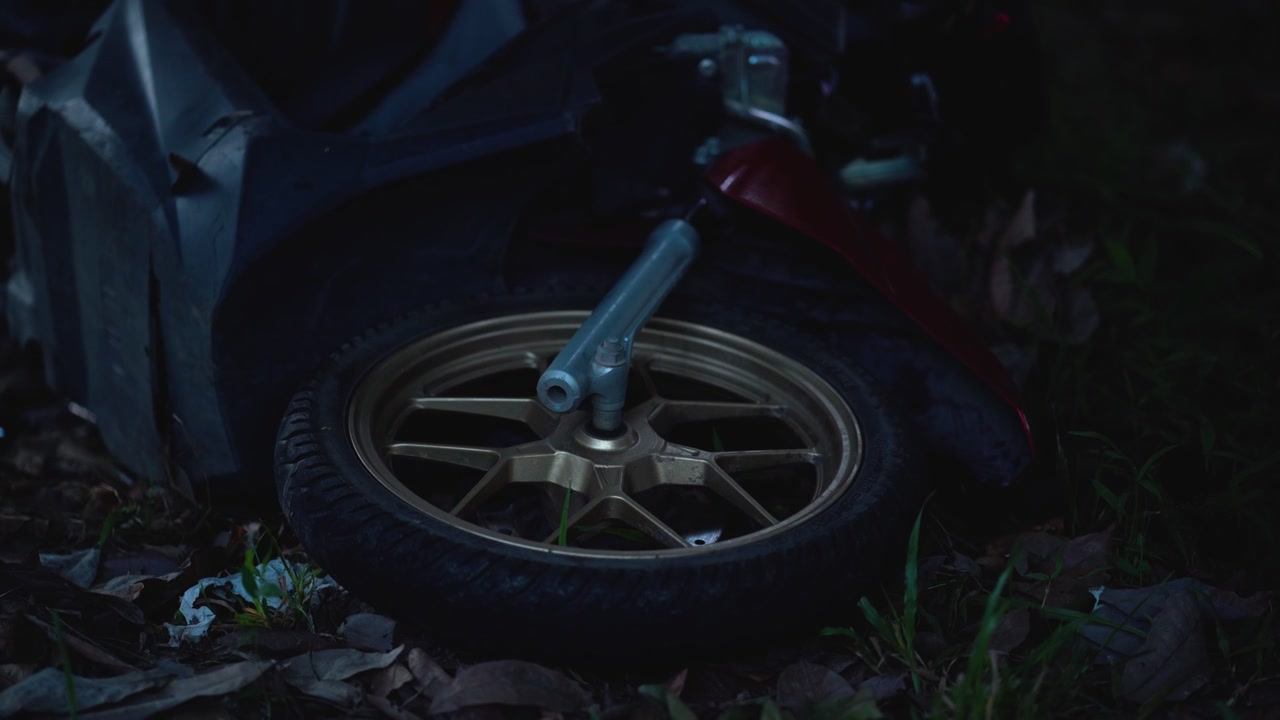 Fallen Motorcycle on Ground at Night with Flashing Emergency Lights