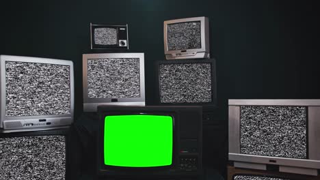 zoom out then fixed shot in a old tv set with green screen among a wall of retro television