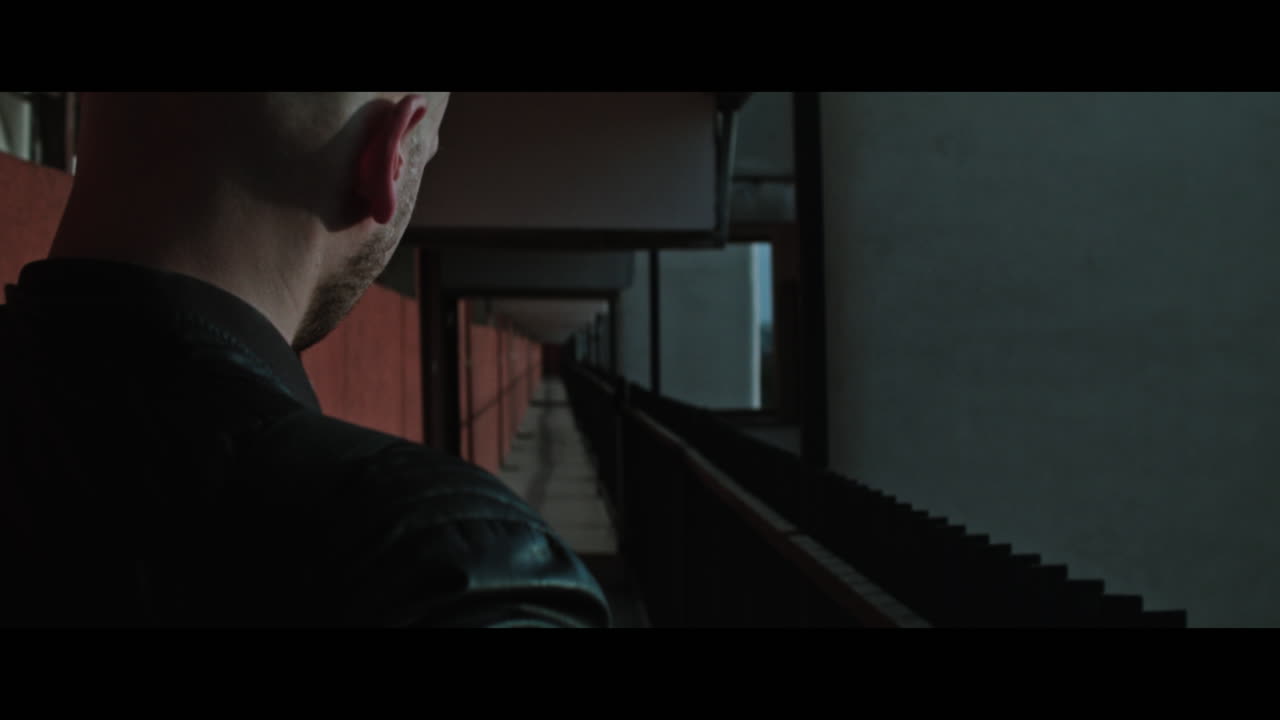 A bald gang member on guard