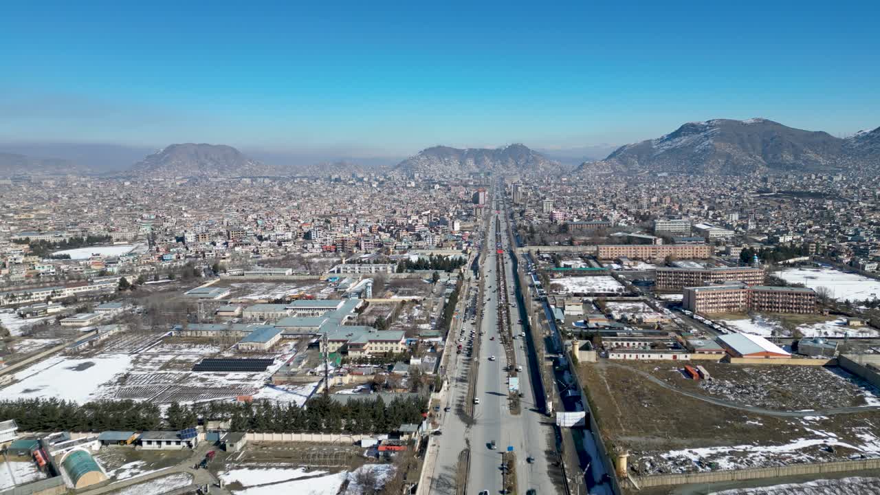 Drone Aerial of Kabul Afghanistan, Busy Traffic in city center against blue sky